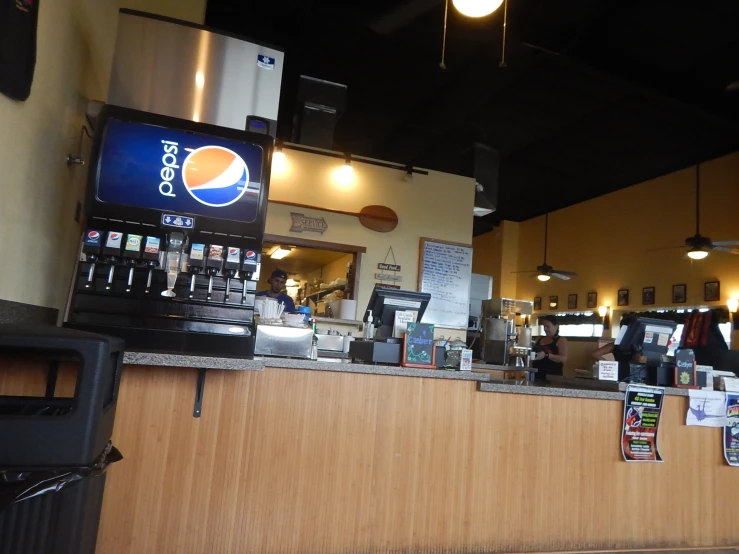 a restaurant counter with a pepsi bottle on it