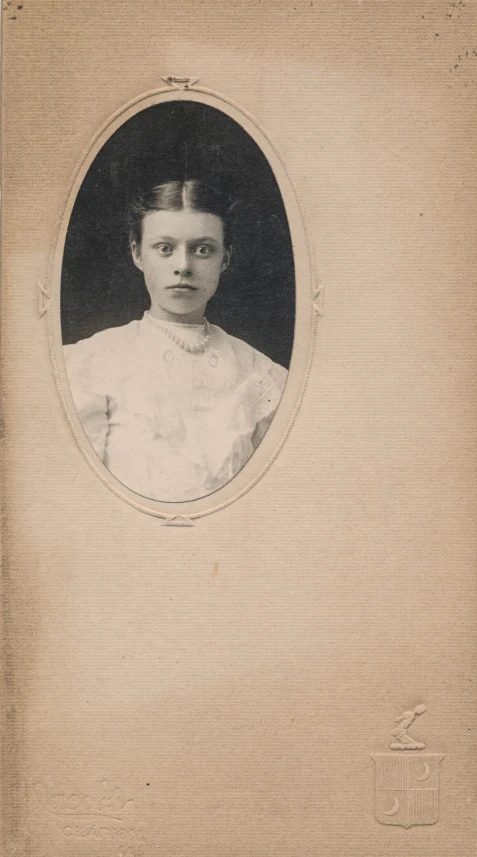 an old picture of a woman in a white dress