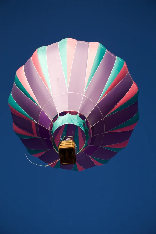 the large colorful  air balloon has a bell for it to lift off