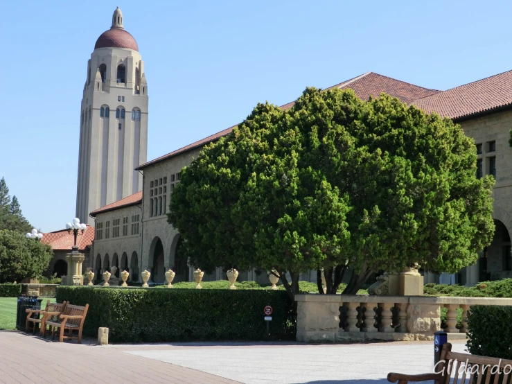 the courtyard outside the building has a large clock tower