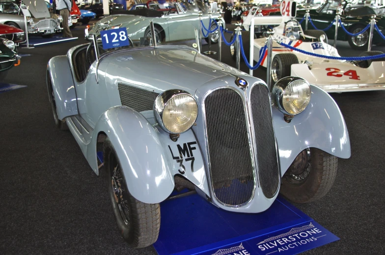 the old vintage cars are lined up on display