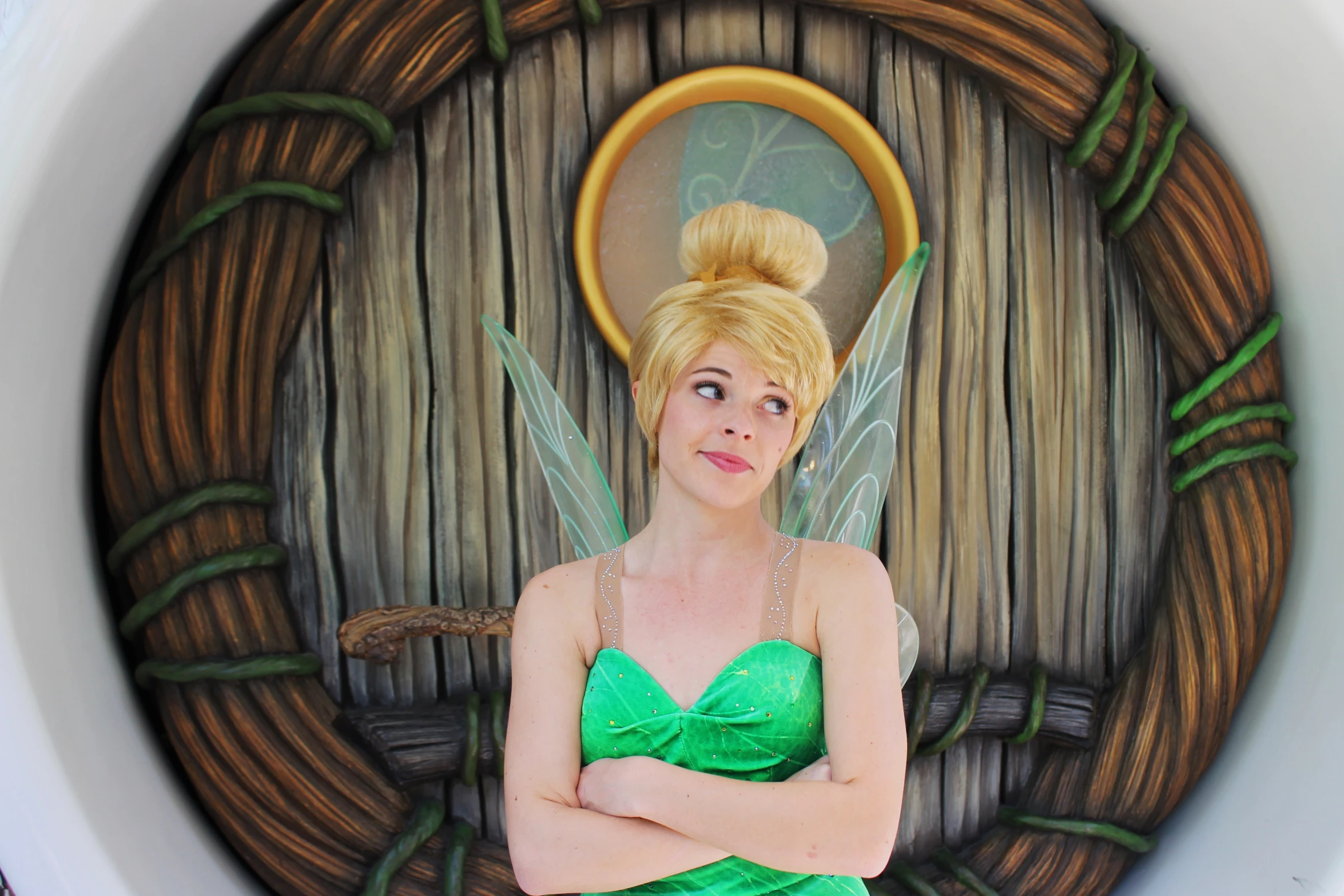 a woman in green posing with her arms crossed