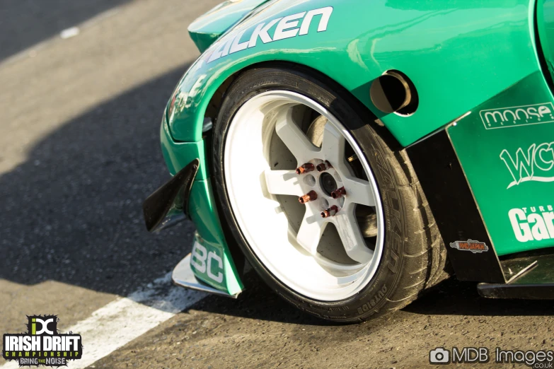 a car with it's tires slightly down on the road