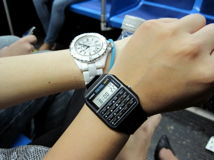 a person wearing a smart watch and using a cell phone