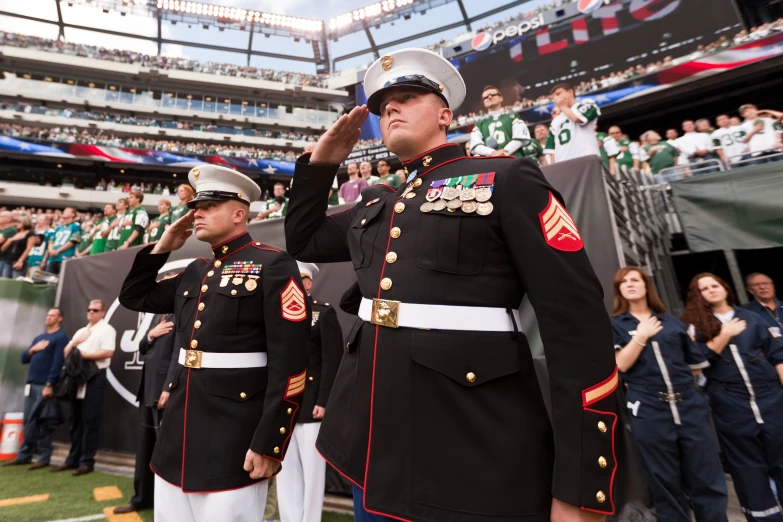 two uniformed military men in front of a crowd