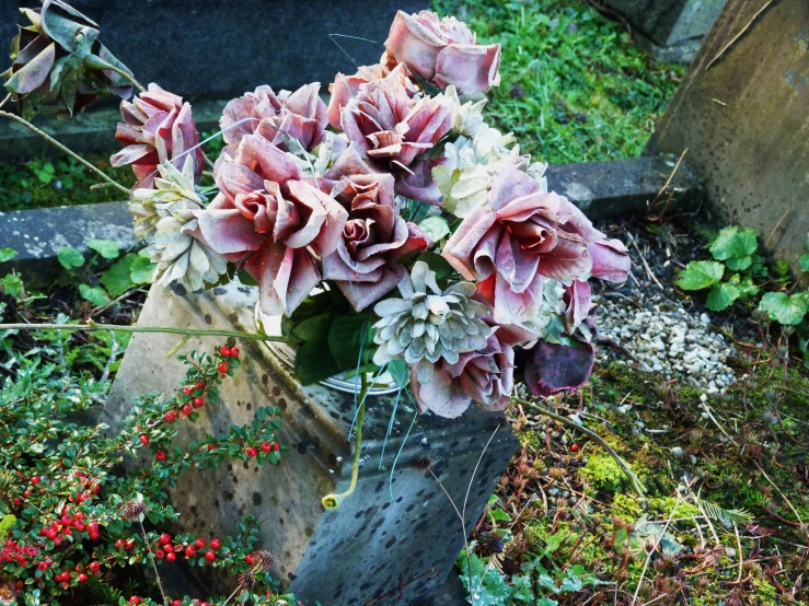 flowers sitting in the middle of a grave