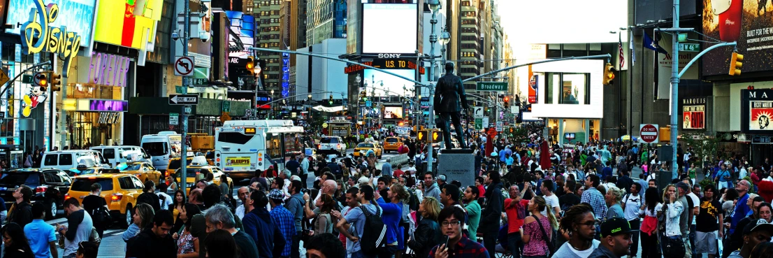 several people are walking down a crowded street