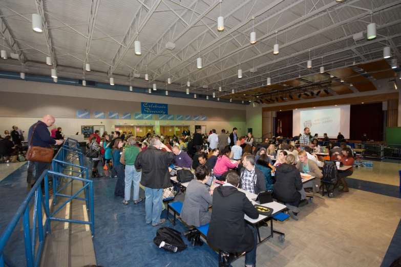 many people in a cafeteria are seated together