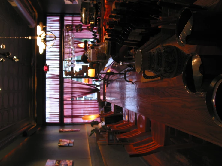 a row of wooden chairs next to a large wine rack