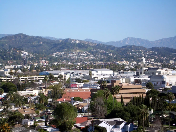 this is a view from above of town with many mountains in the distance