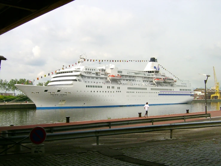 two cruise ships parked side by side along side the dock
