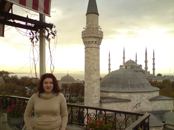 a woman posing in front of a beautiful view