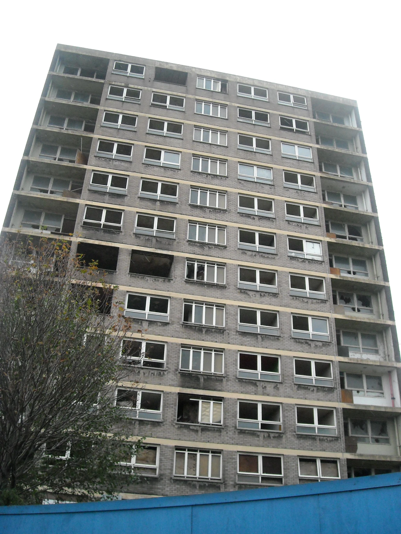 a tall building with several windows and no one around