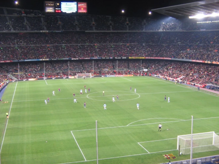 an empty stadium with people standing around on the field