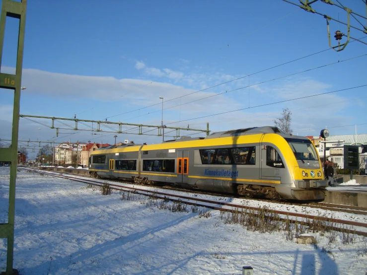 train is passing on a snowy railroad track