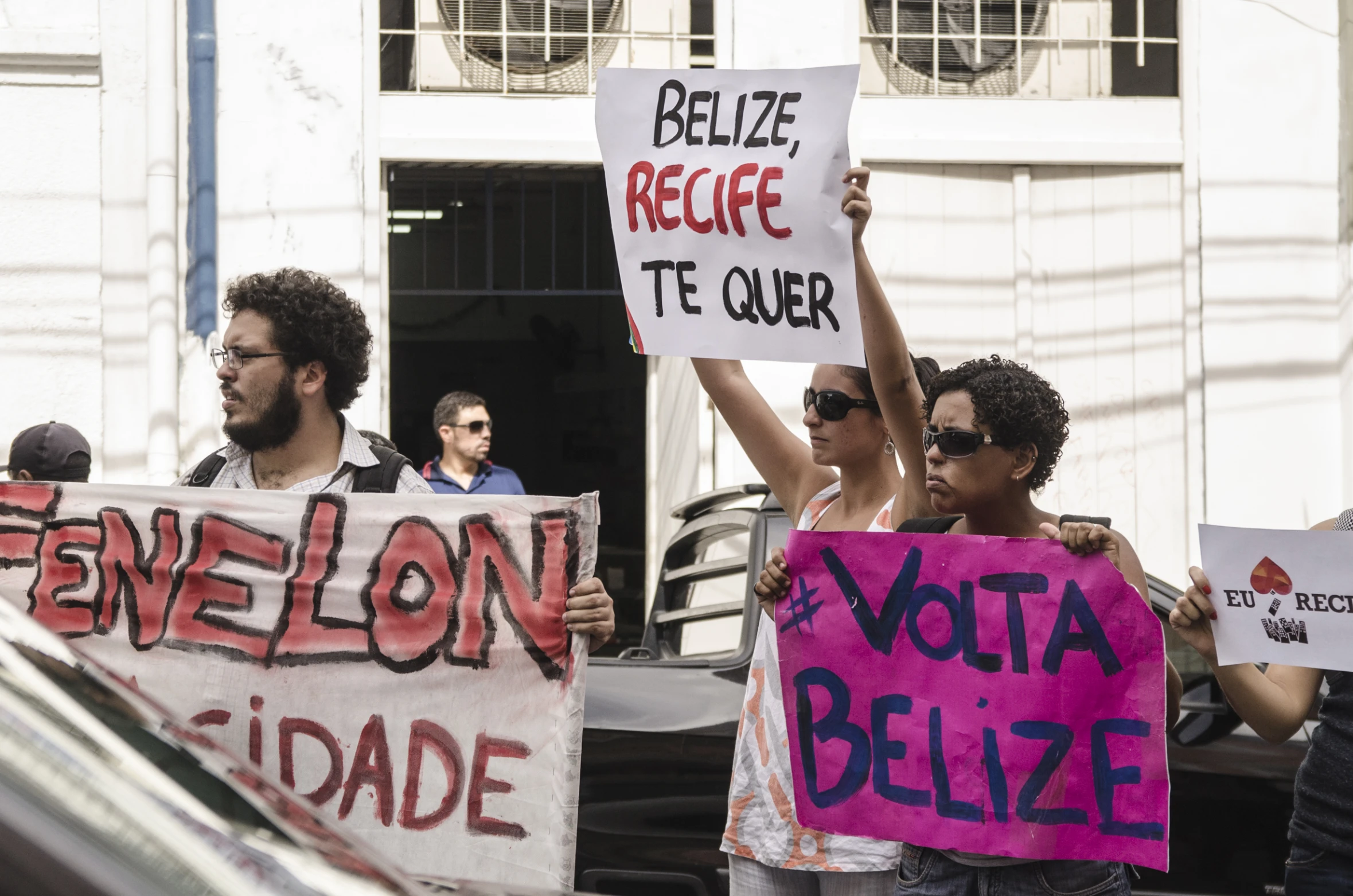 people holding signs in front of building with signs reading'petition to quiet vote to free guer '