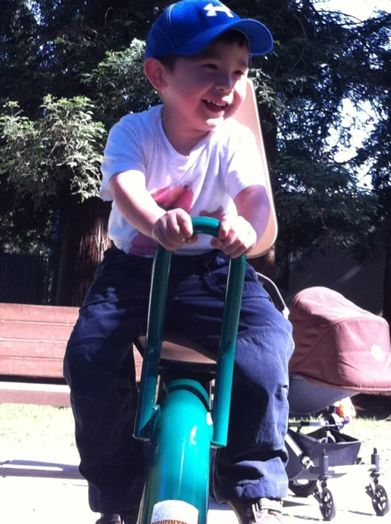 a little boy on a tricycle in the park