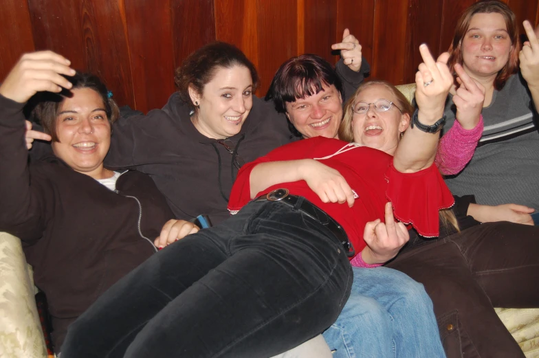 a group of people with thumbs up on a couch