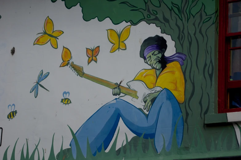 a woman is painting on the wall with erfly paint