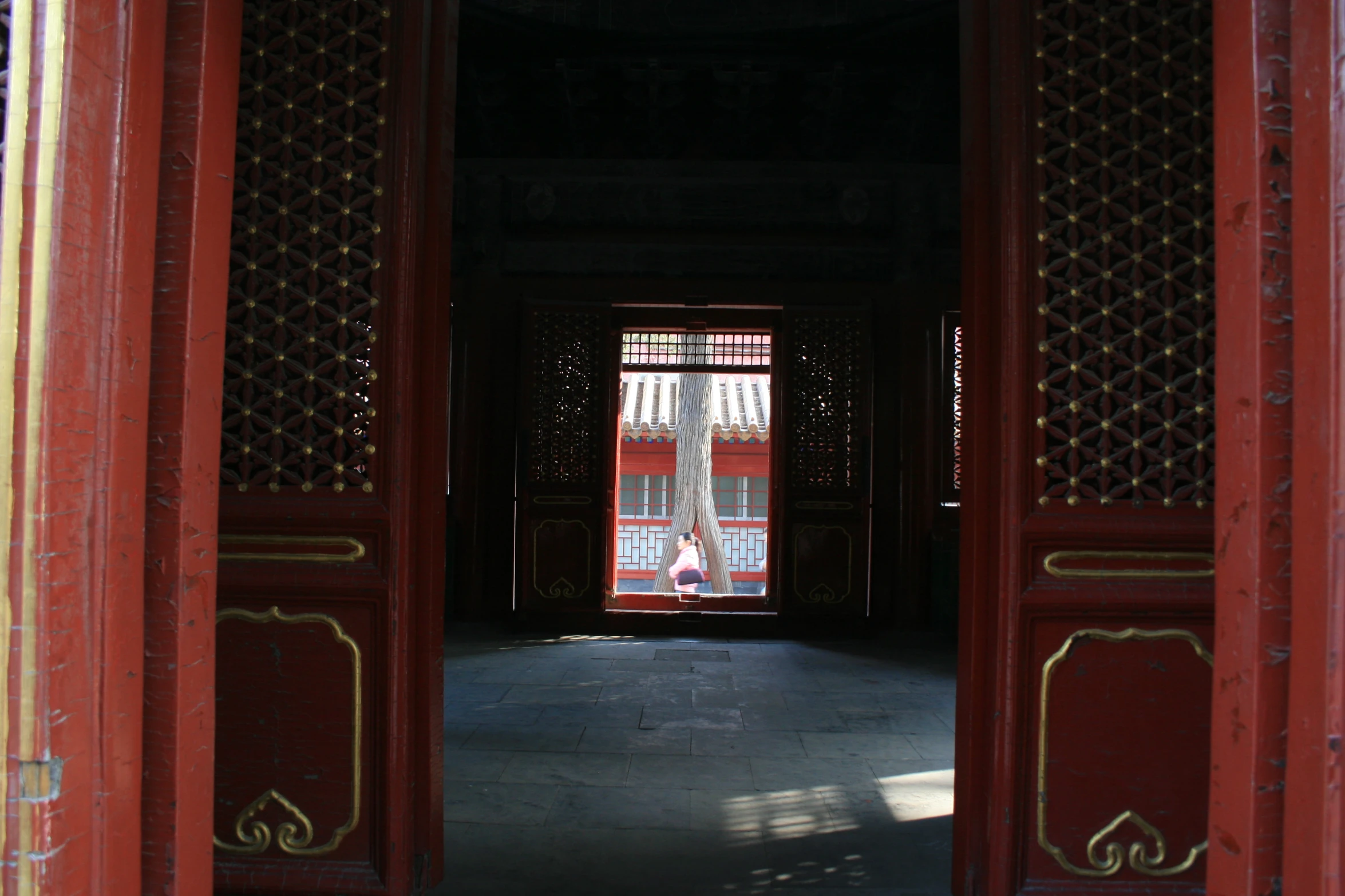 a po taken through three red gates in front of an entrance