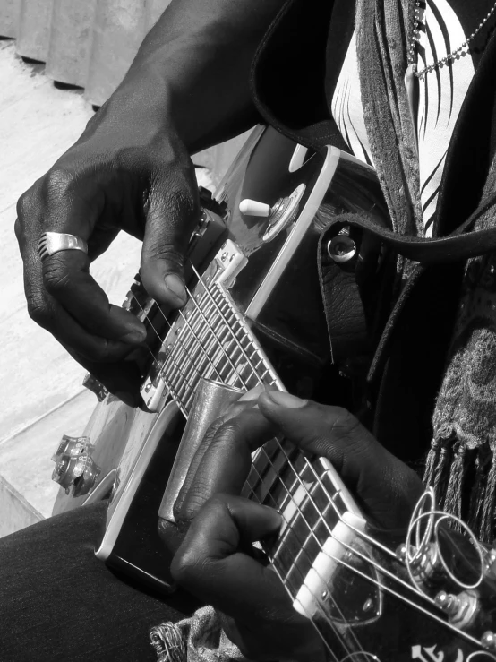 the hands of a woman who is playing a guitar