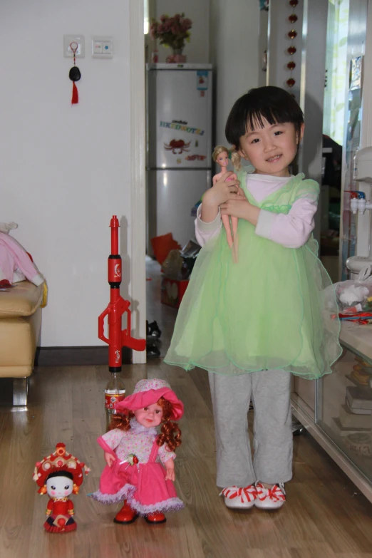 two small children posing for the camera with doll