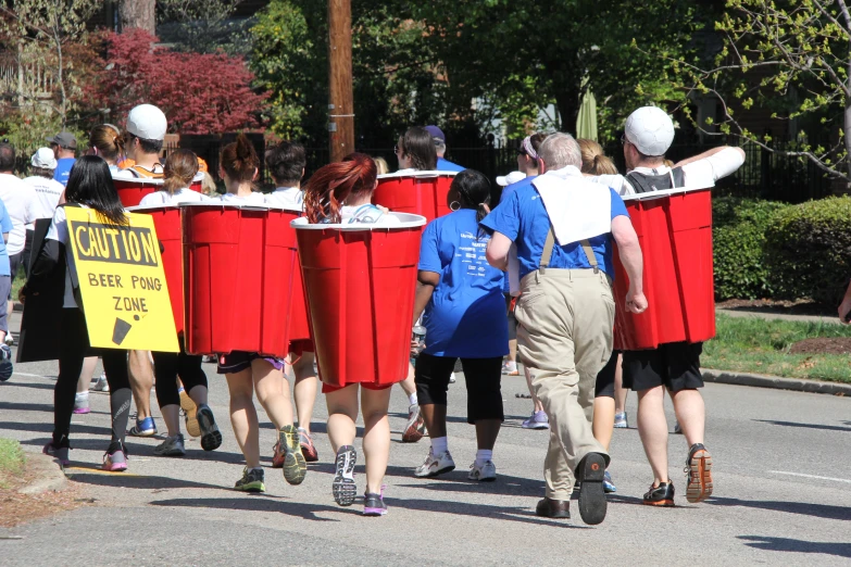 some people walking down a road with red outfits