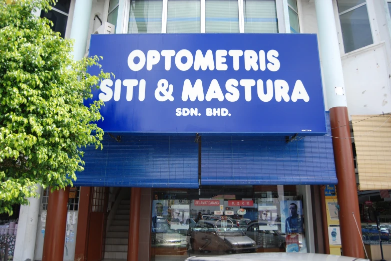 a blue sign hanging from the side of a building