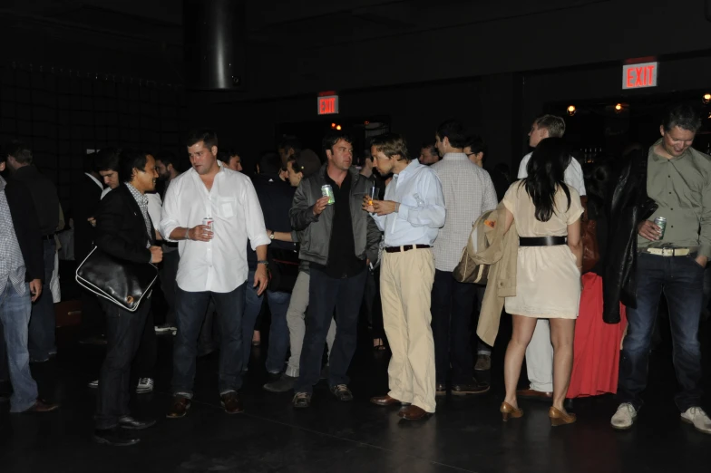 several people are standing together near a wall