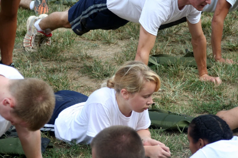 people sit and lay on the ground near each other