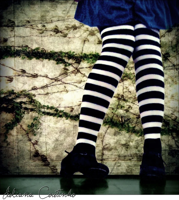 a woman in  socks and tights posing for the camera