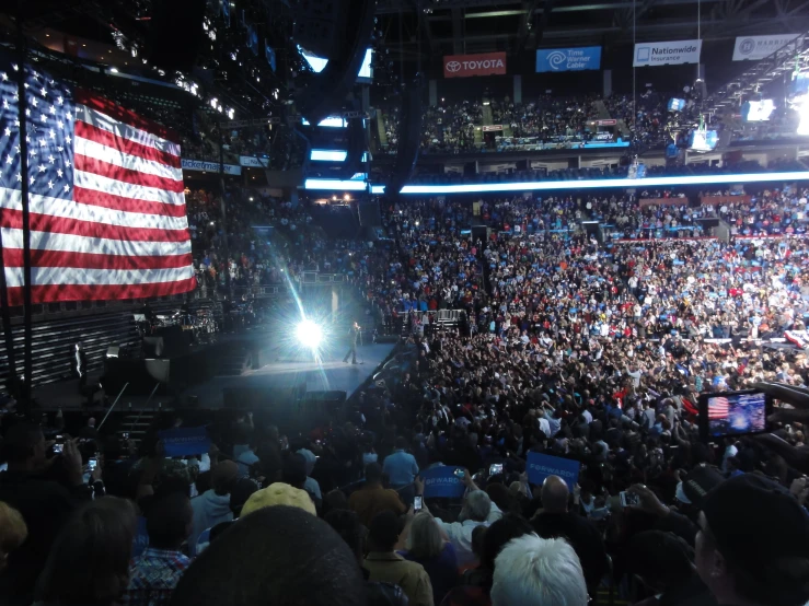 a large crowd is watching an event with lights and people