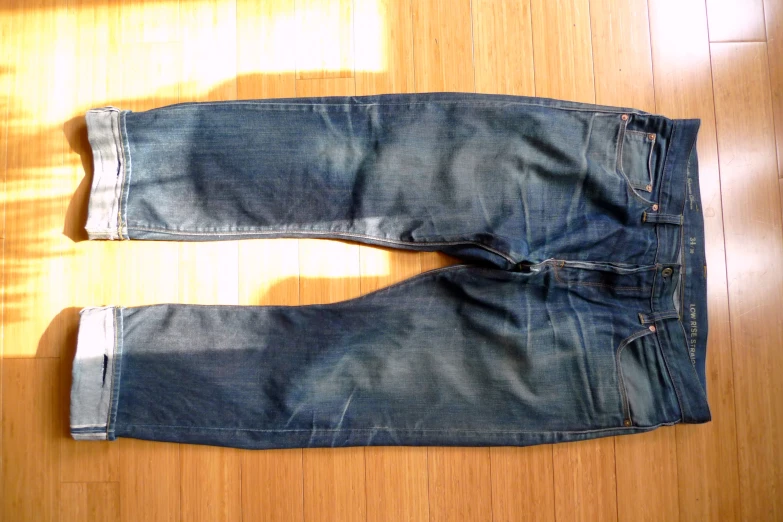 a piece of worn denim with the bottom ripped off