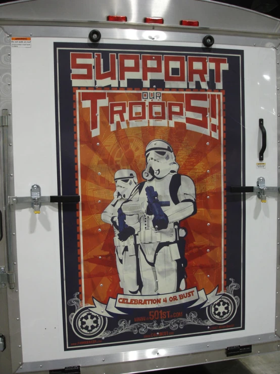 a transport vehicle has a propaganda poster on the side of it