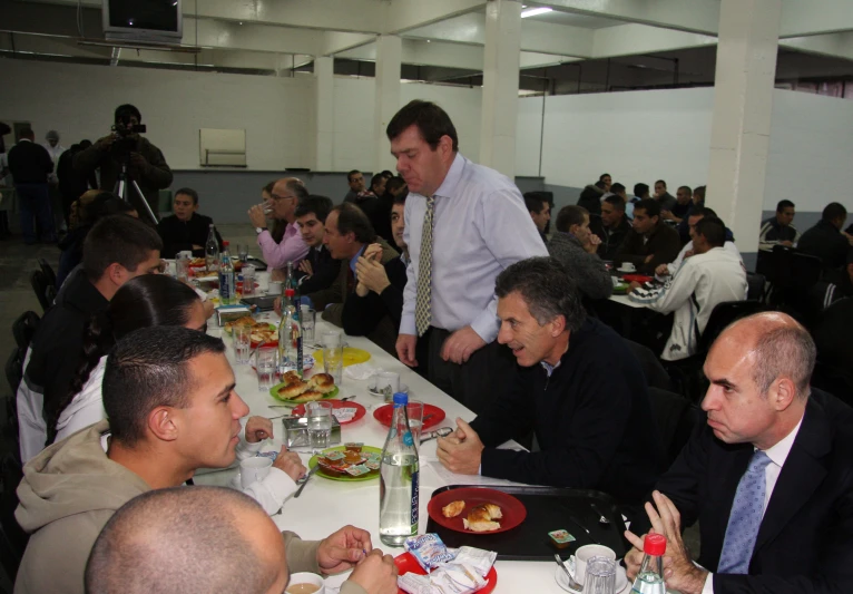 a large group of people eating dinner at tables