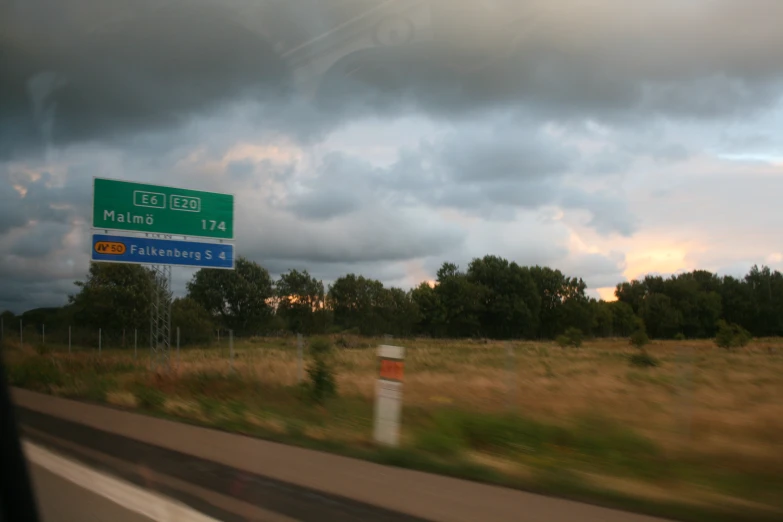 a highway sign that is near the side of a road