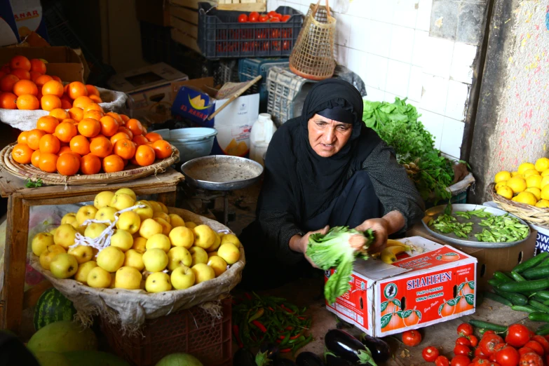 a woman wearing a turban around a market with fruits and vegetables
