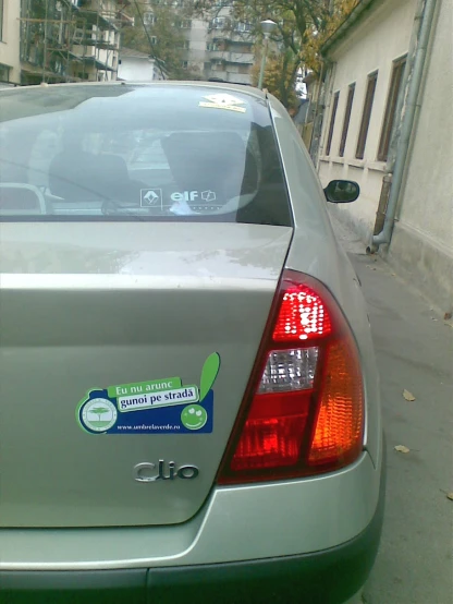a close up view of a silver car with the stickers