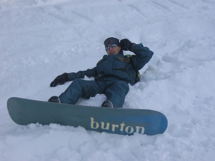 man on a snowboard that is partially buried in the snow
