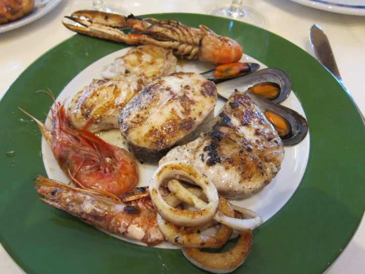 a plate with lobsters and some other foods
