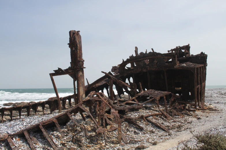 a wrecking boat sitting on top of a beach