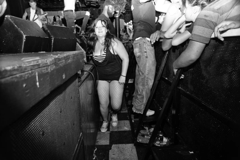 woman standing in front of a crowd of people on a bus