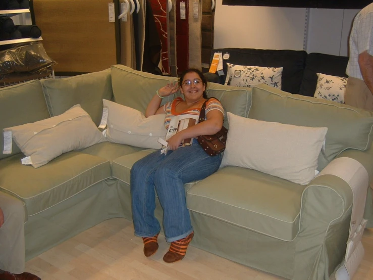 a woman sitting on a couch and talking on the phone