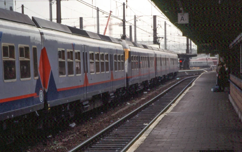 a subway train is parked on the railroad tracks