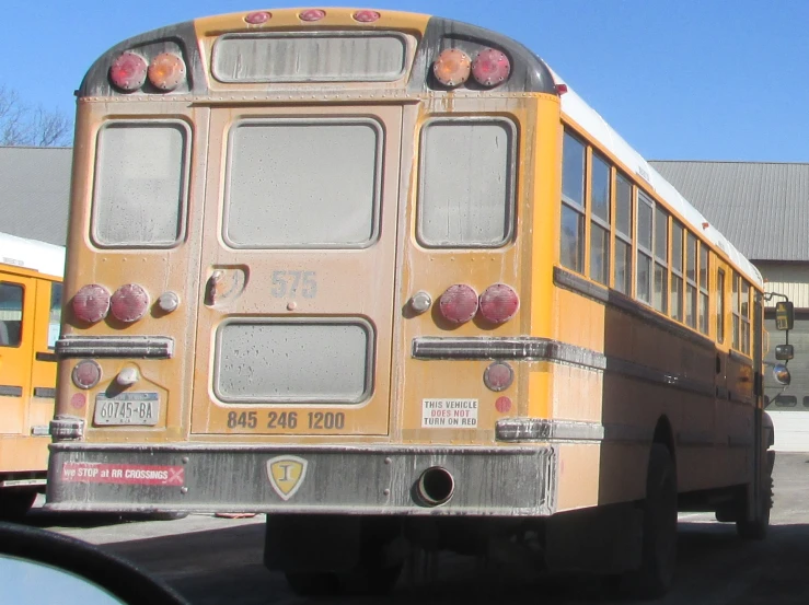a yellow school bus driving down the street