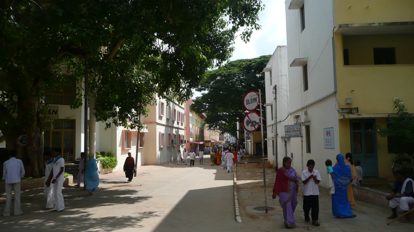 a group of people standing around a small street