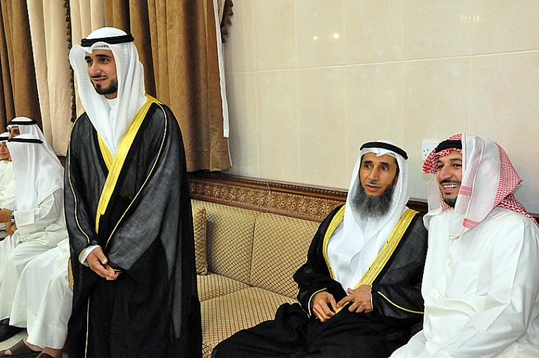 men in traditional dress sitting on a couch