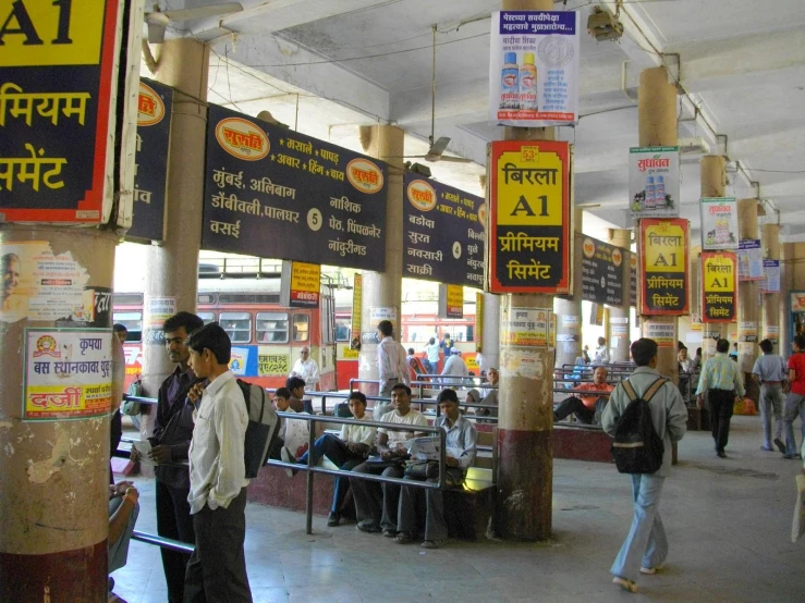 people are standing around in an asian train station