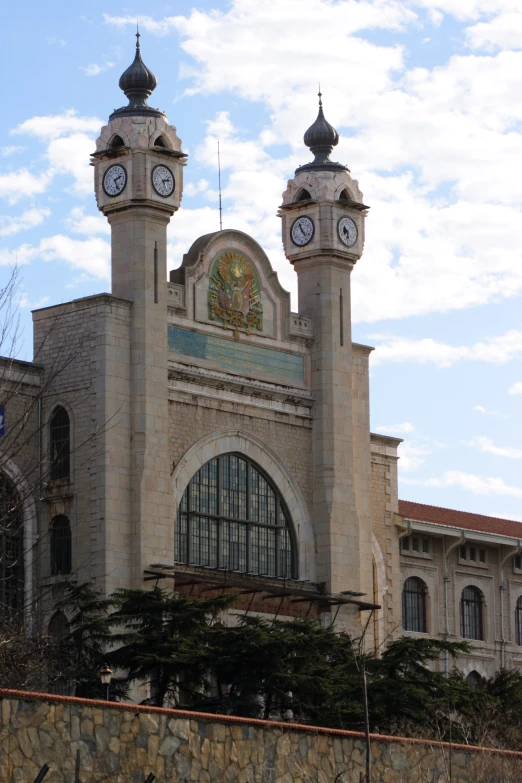 a castle like building with some clocks on each of it's towers