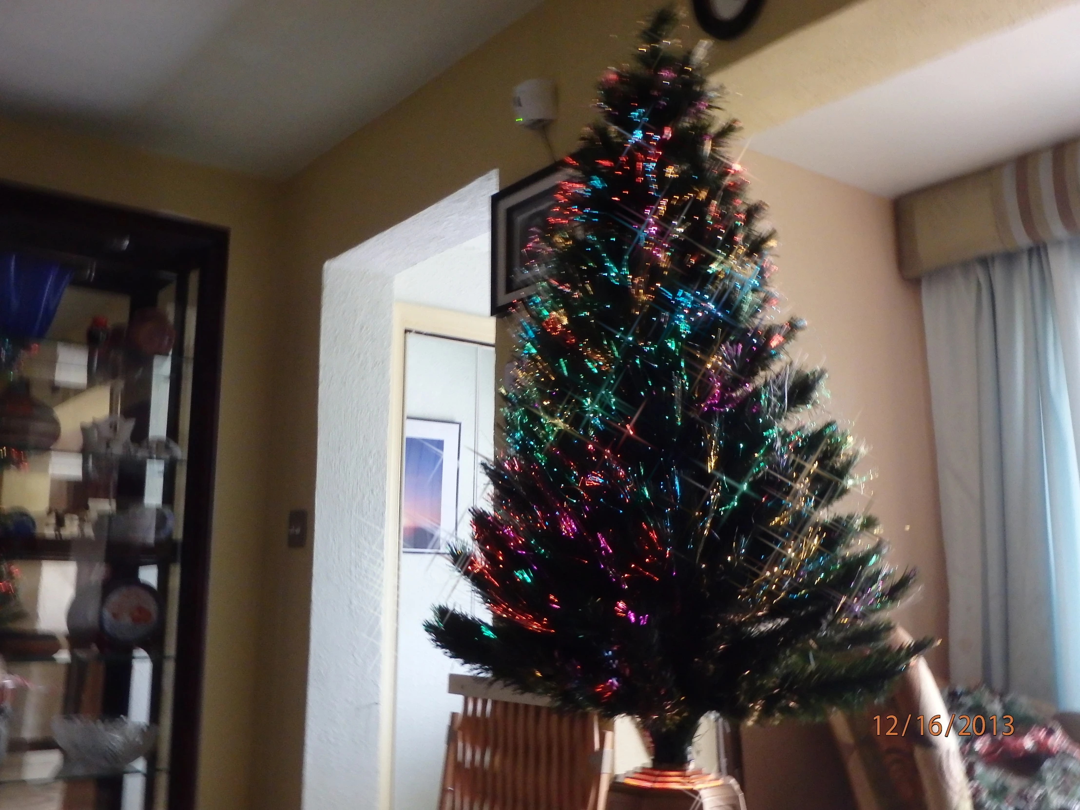 a decorated christmas tree sits in the middle of a room